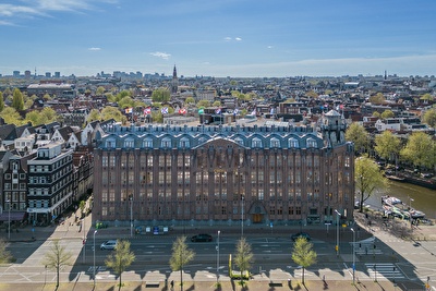 Grand Hotel Amrâth Amsterdam with a cityscape in the background.