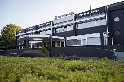 Amrâth Airport Hotel Rotterdam, modern building with a business-like design, wide staircase, and spacious entrance.